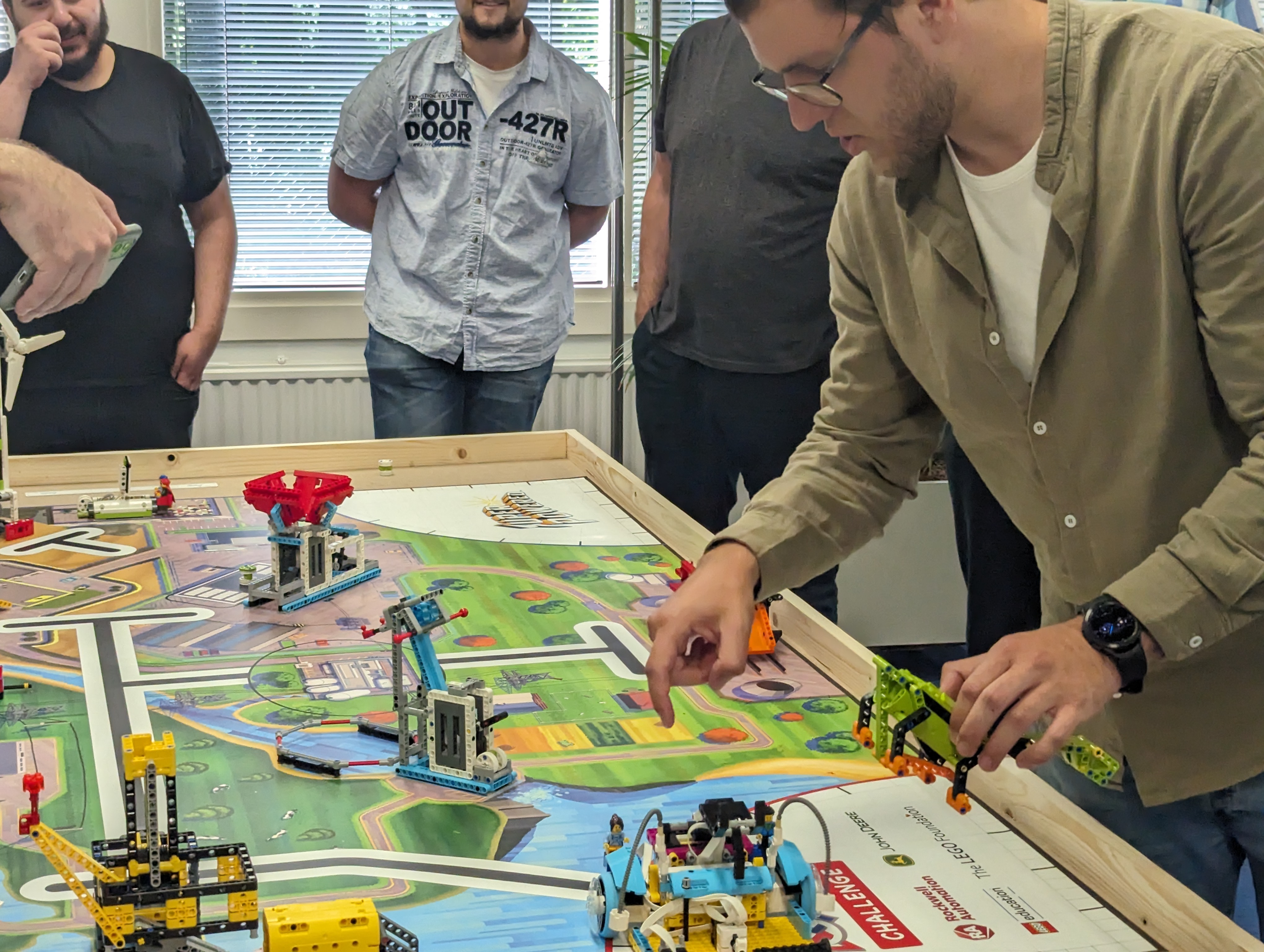 A contestant calculating exactly where to go. Such a pathfinder! A contestant is looking at the board figuring out where the robot needs to go
